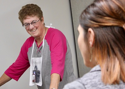 Female patient and female Nurse smiling during therapy