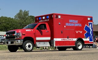 SECHD EMS Service staff memebers standing outside in front of a ambulance truck.