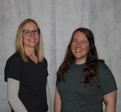 Two occupational therpist standing next to each other, smiling.