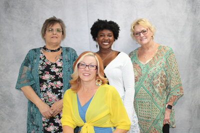 Group picture of four females. LTC activities department staff.