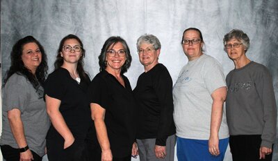 Hospice Team standing side by side, smiling.